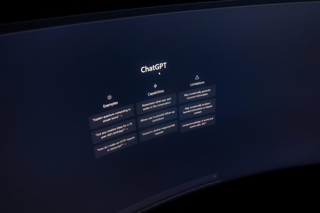Close-up of a computer screen displaying ChatGPT interface in a dark setting